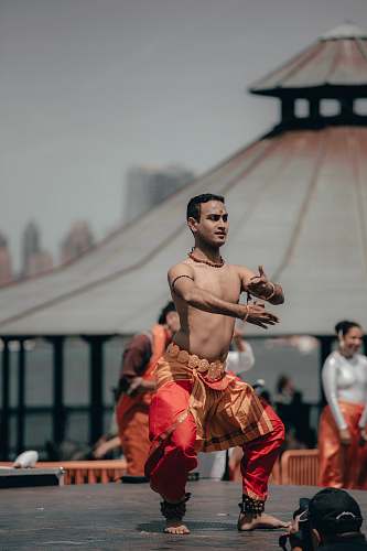 dance pose man wearing red and orange pants leisure activities